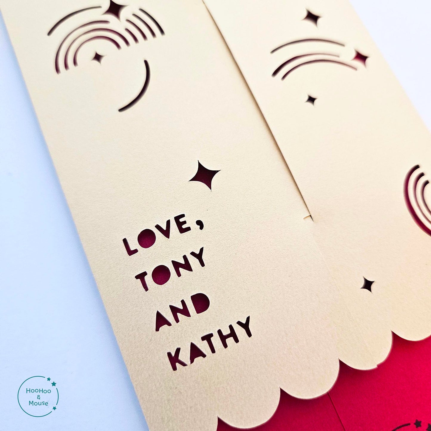 A detail shot of the back of a red envelope, customized with "Love, Tony and Kathy" in paper cut lettering